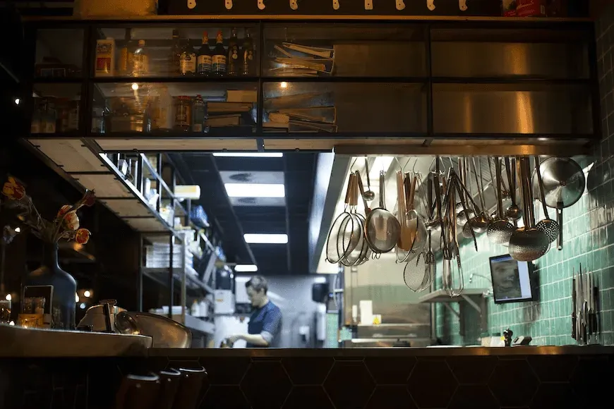 A digital kitchen display screen placed in a restaurant's kitchen.
