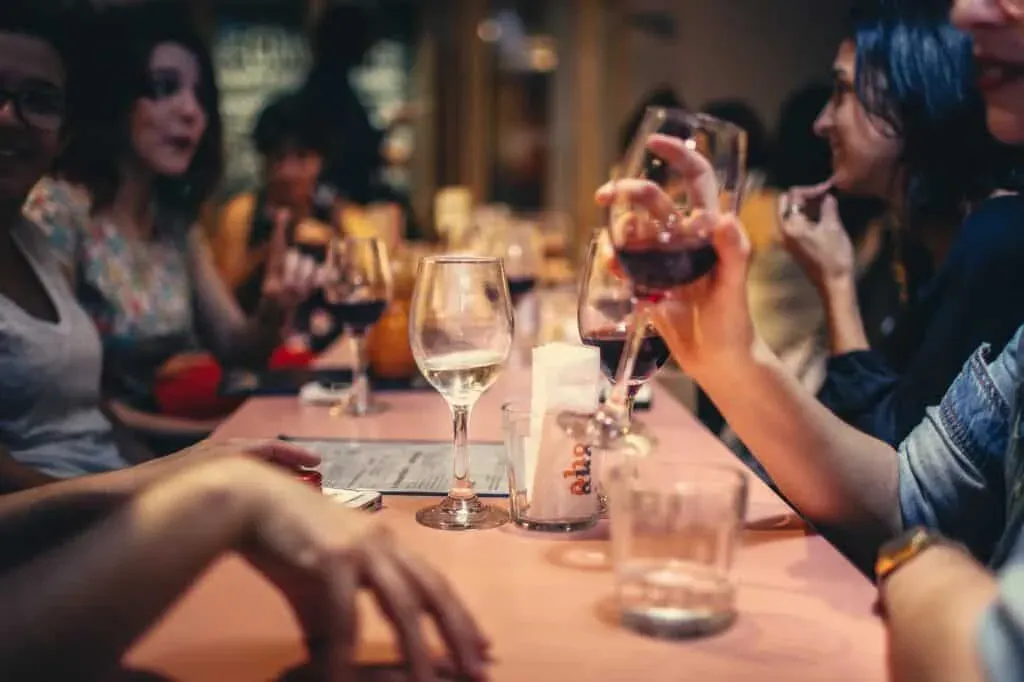 Guests enjoying wine together at a lively dinner event