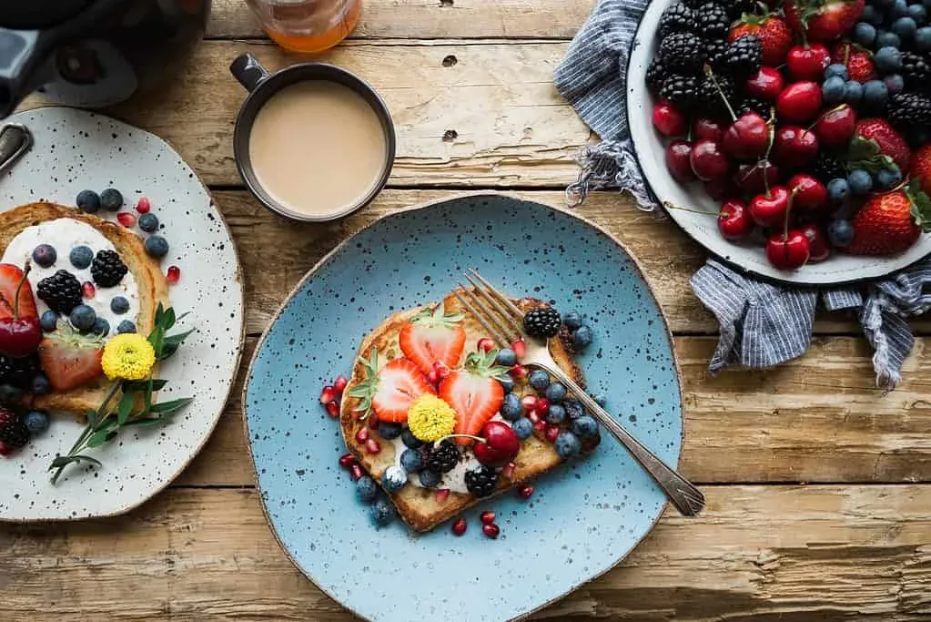 Brunch café table with weekend dishes ready for arriving guests